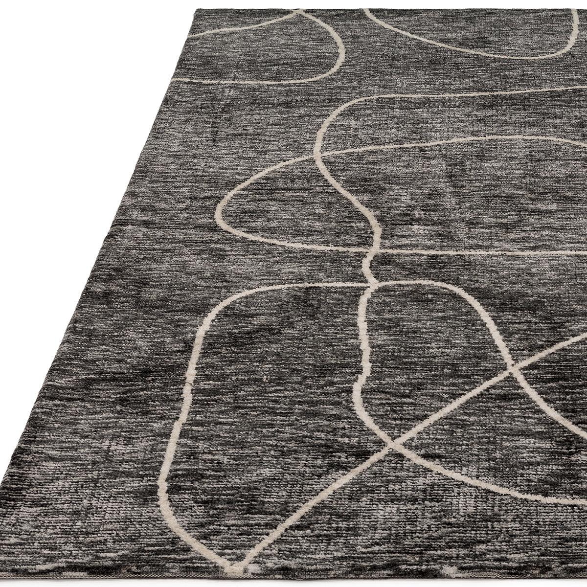 Asiatic Mason Linear Designer Rug featuring abstract curved-line pattern in cream on charcoal background, machine-made polypropylene