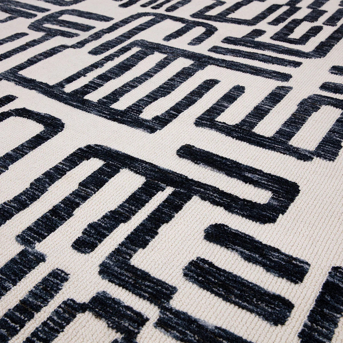 Asiatic Mason Script Designer Rug featuring geometric script pattern in navy blue on ivory background, hand-tufted wool