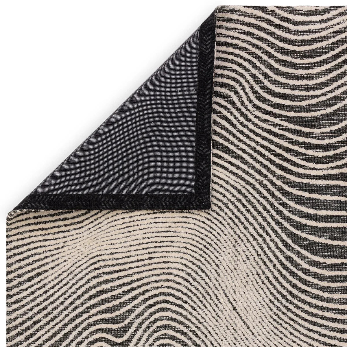 Asiatic Mason Magnitude Black Designer Rug featuring zebra stripe pattern in black and ivory on cream background, hand-tufted wool