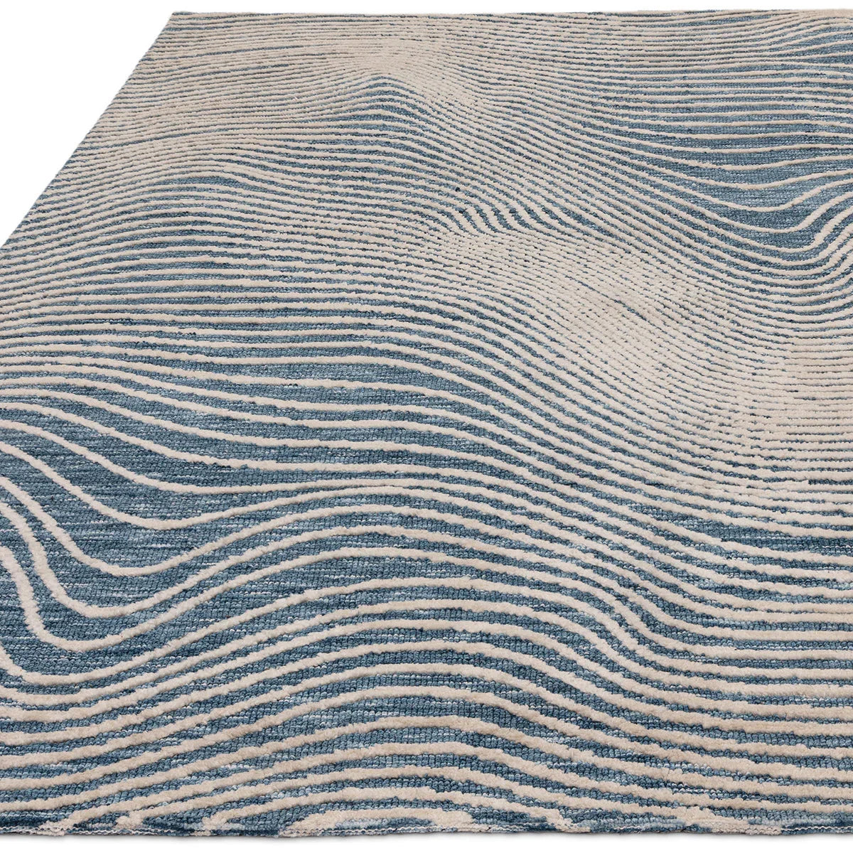 Asiatic Mason Magnitude Blue Designer Rug featuring abstract wave pattern in navy blue, cream and light blue on cream background, hand-tufted wool