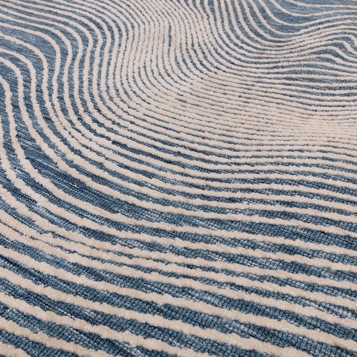 Asiatic Mason Magnitude Blue Rug featuring abstract wavy stripe in navy, azure and cream on beige, hand-tufted wool