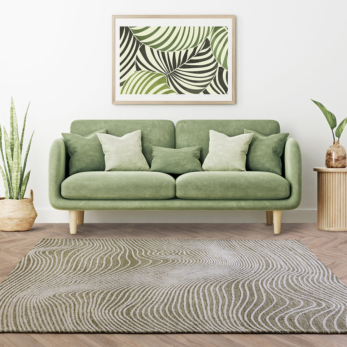 Green sofa in a living room with a abstract leaf print painting on the wall.