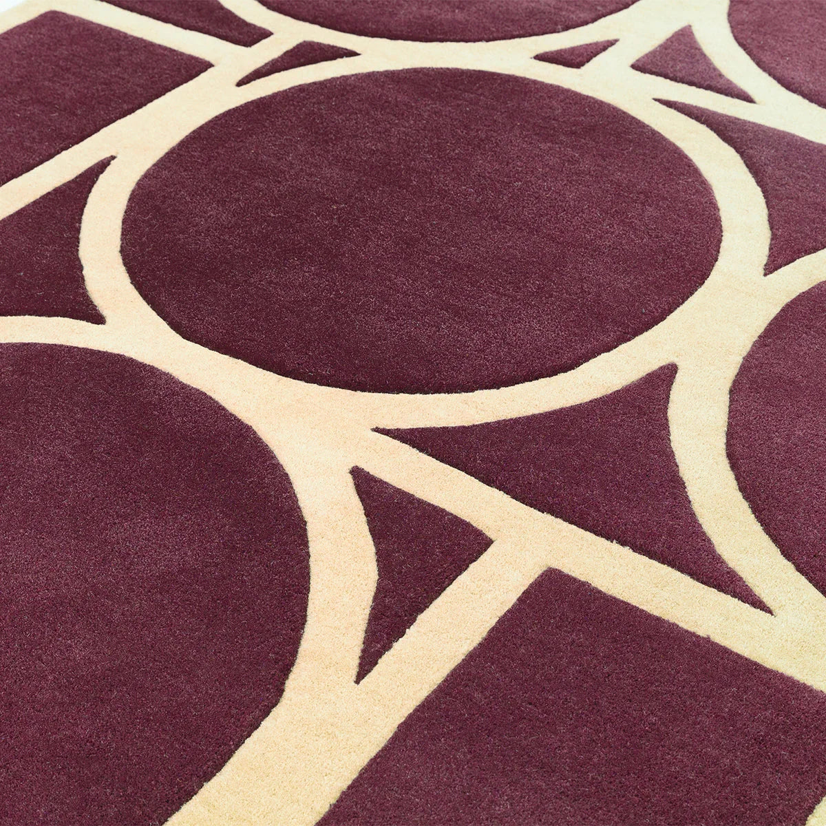 Asiatic Metro Plum Designer Rug featuring abstract circular lattice pattern in cream on plum background, decorative rug