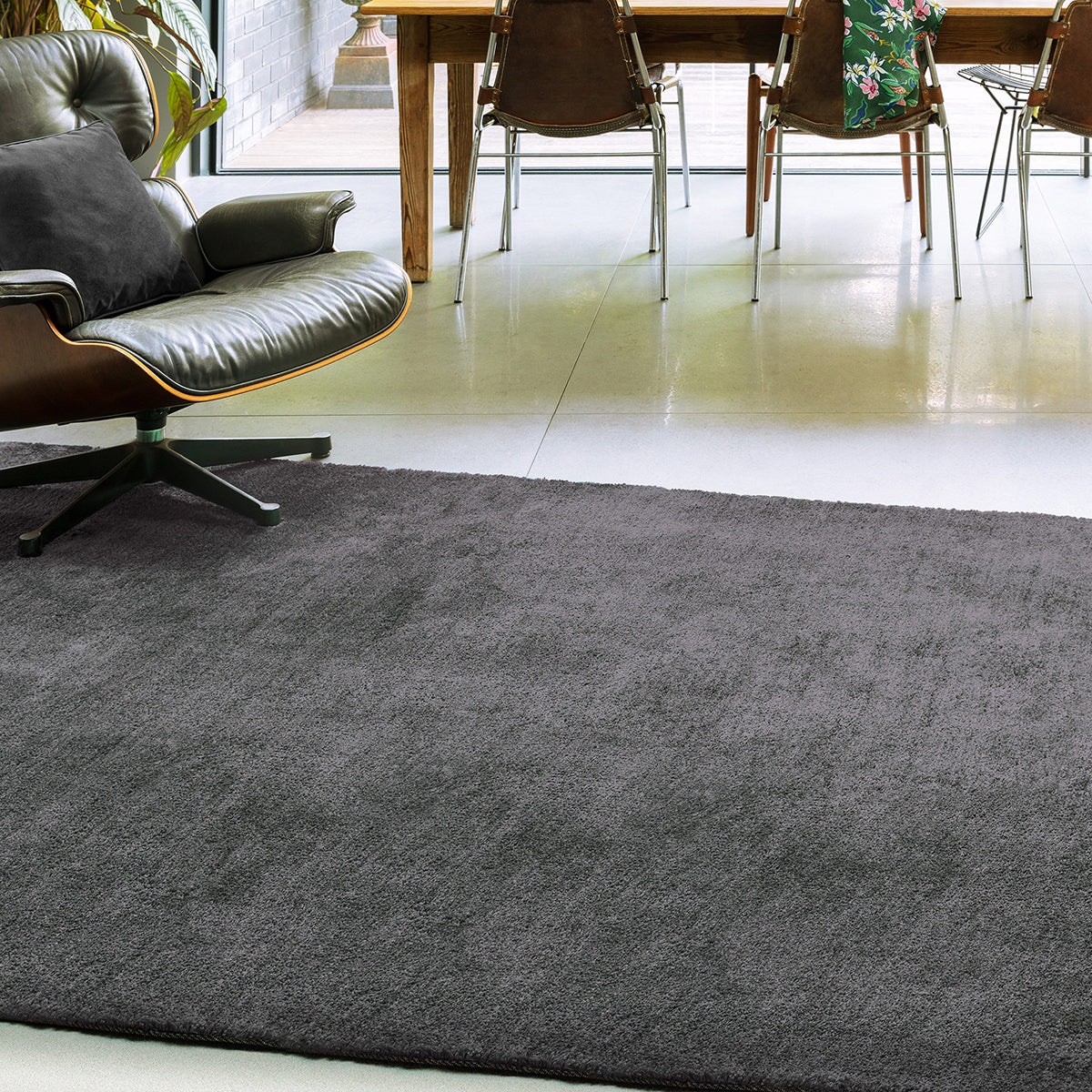 Gray rug in a room with a table and chairs
