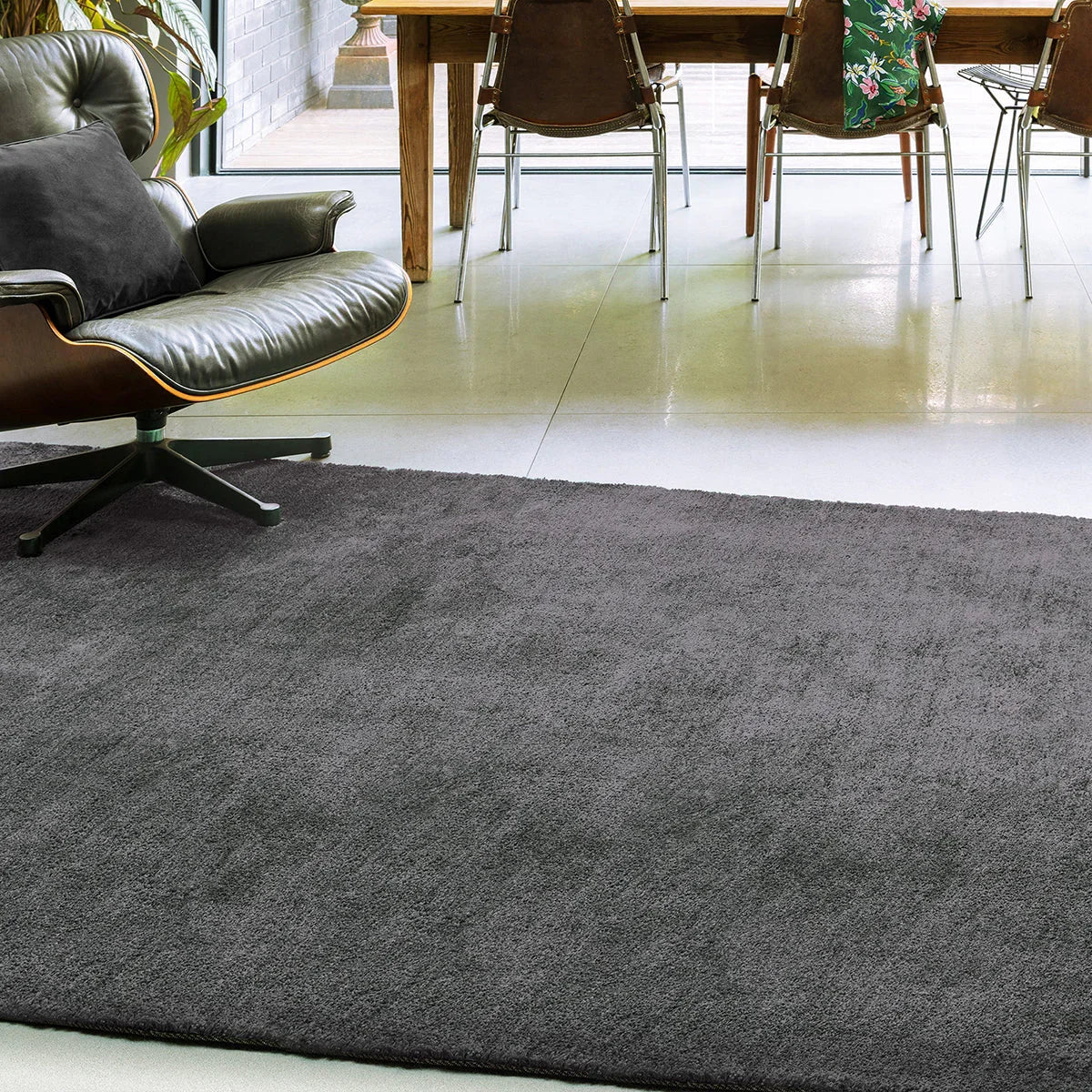 Gray rug in a room with a table and chairs