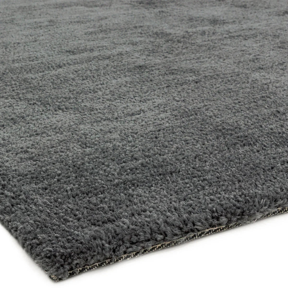 Asiatic Milo Grey Designer Rug with plush shag texture in charcoal-grey on grey background.