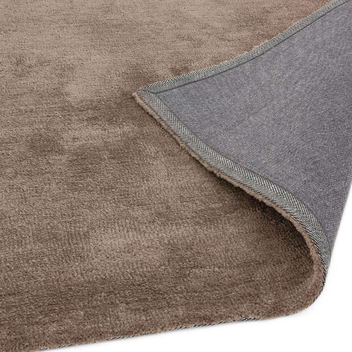 Asiatic Milo Mink Designer Rug featuring solid mink-brown textured pile with blue-grey backing and chevron-edge border, machine-made wool