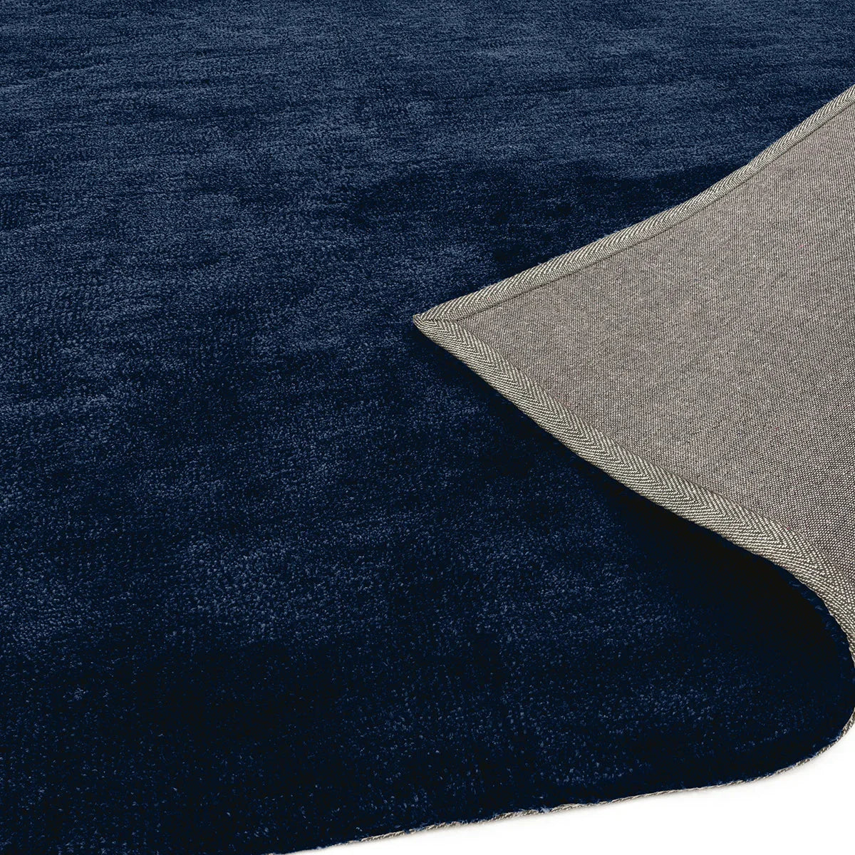 Asiatic Milo Navy Designer Rug featuring solid navy and deep blue texture on light grey/beige backing, hand-tufted wool