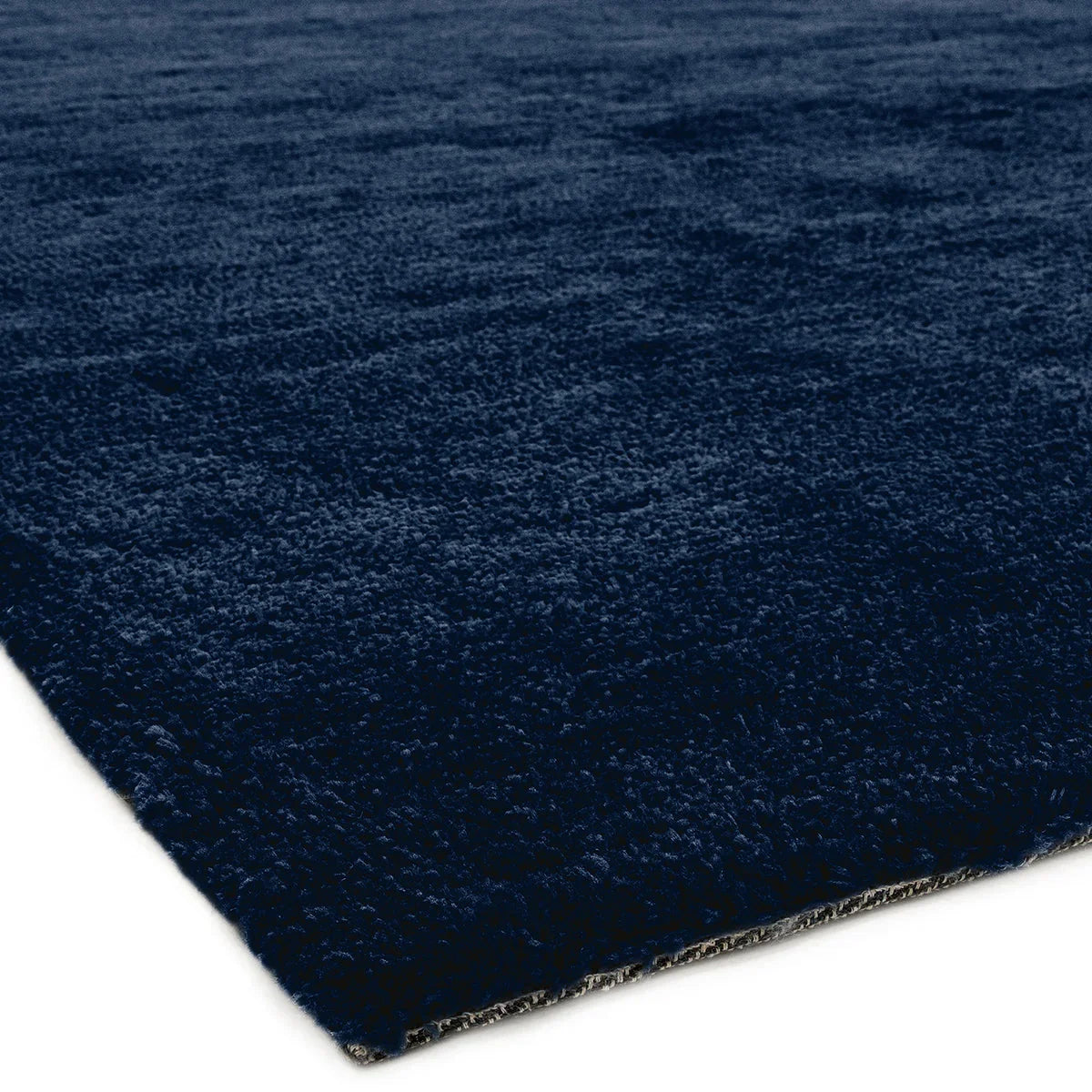 Asiatic Milo Navy Designer Rug featuring solid textured field in navy blue on white background, hand-tufted wool