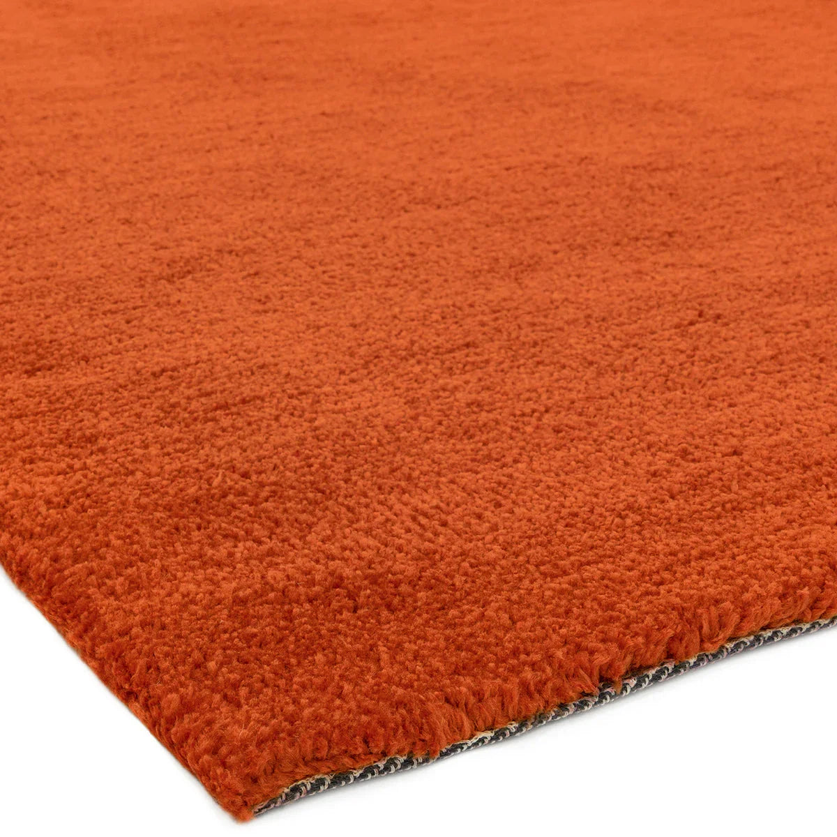 Asiatic Milo Rust Designer Rug featuring solid colour shag in rust orange on light backing, hand-tufted wool