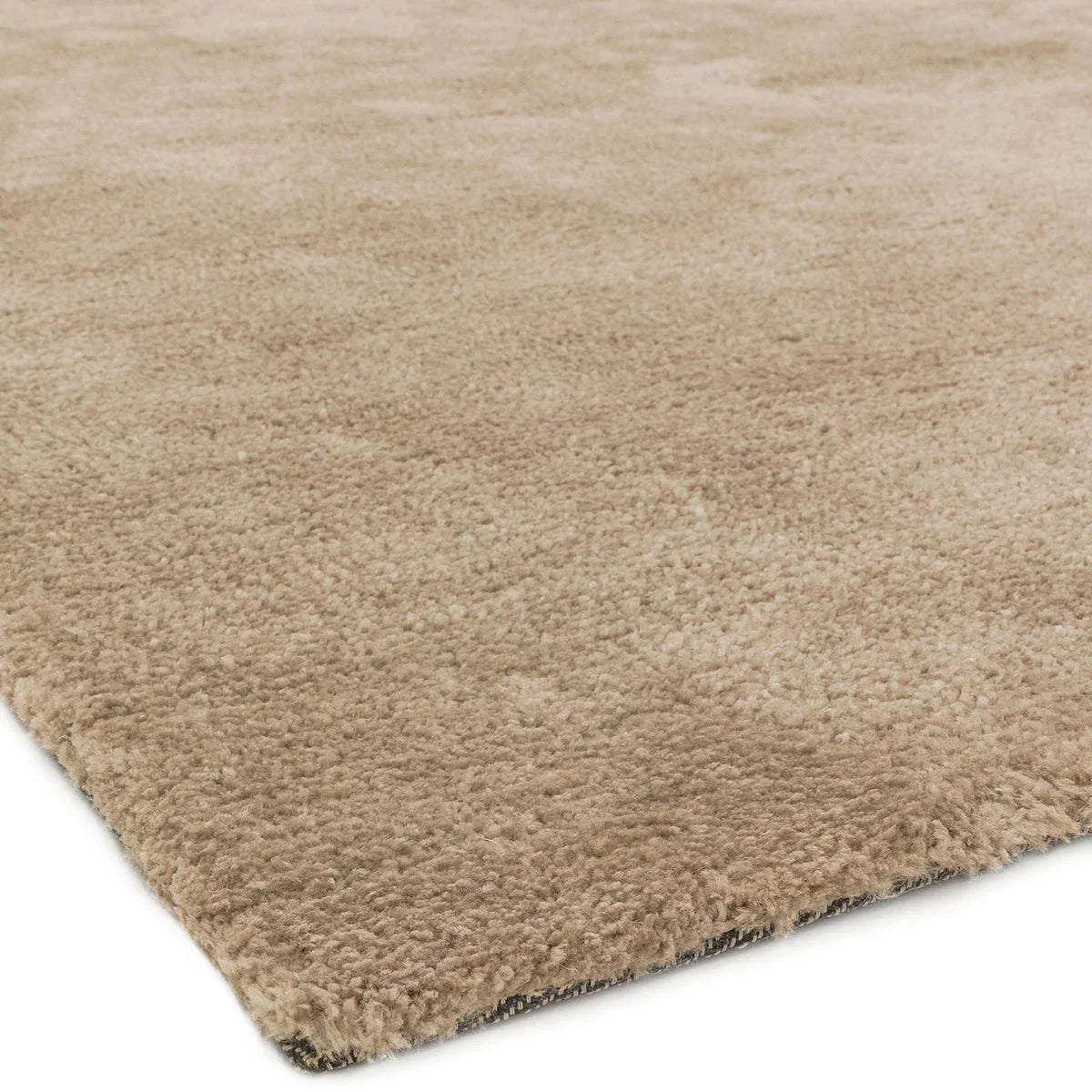 Asiatic Milo Sand Designer Rug featuring solid shag in sandy beige on cream background, machine-made wool