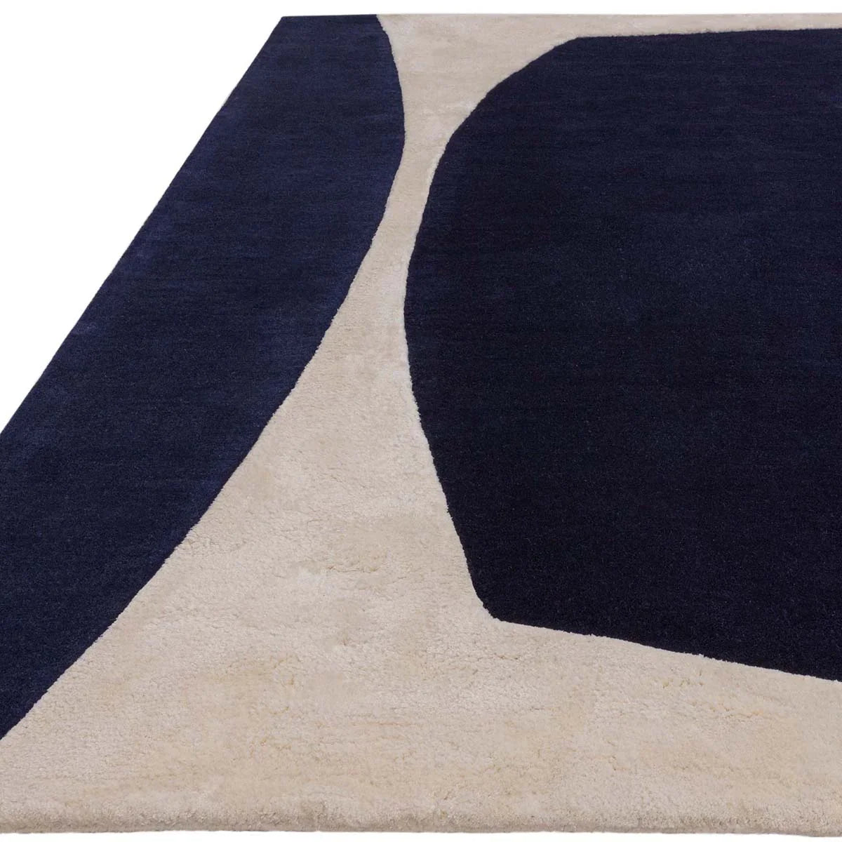 Asiatic Matrix Indigo Designer Rug featuring abstract geometric shapes in navy blue and beige on cream background, hand-tufted wool