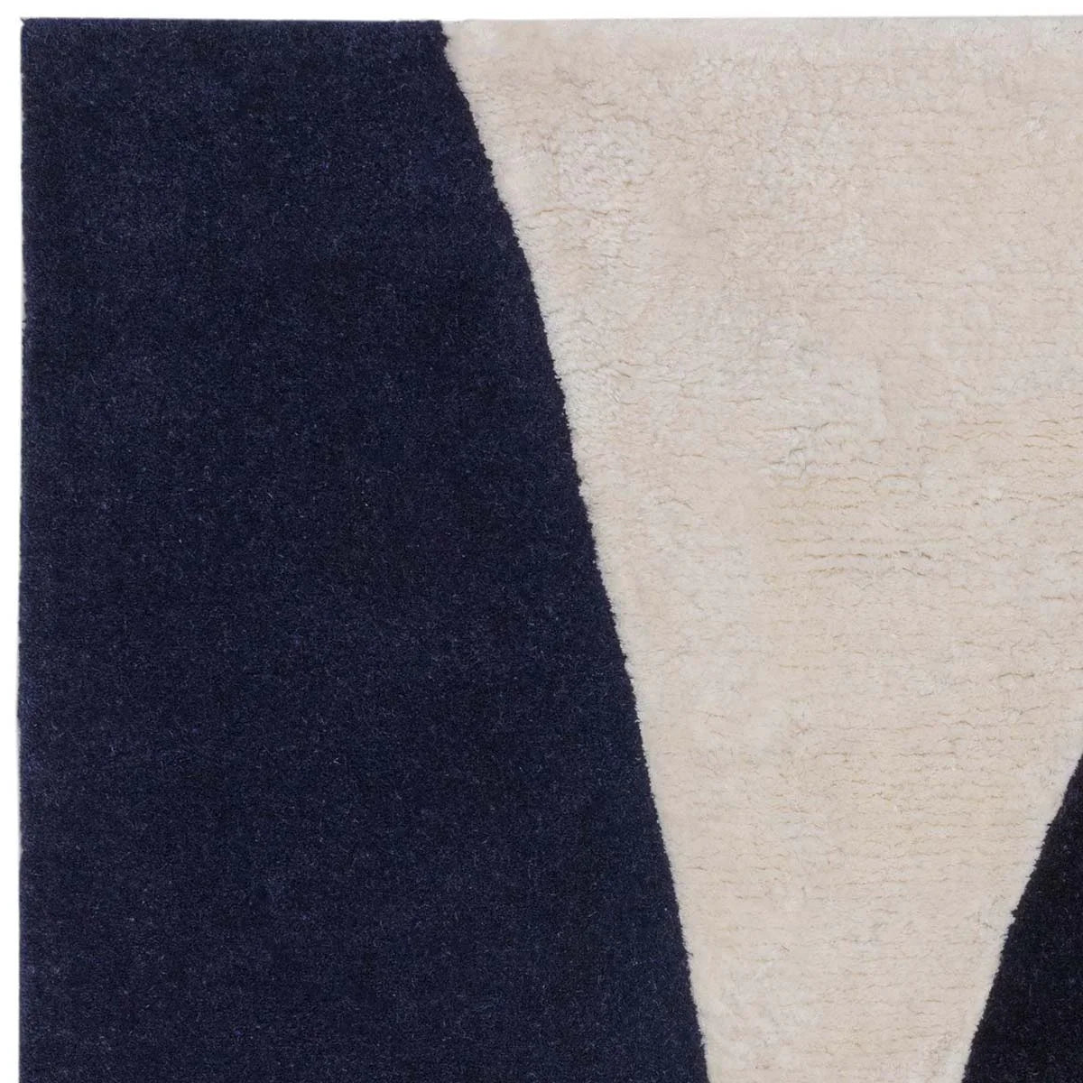 Asiatic Matrix Signature Indigo Rug featuring abstract geometric pattern in navy indigo and cream on beige background, hand-tufted wool
