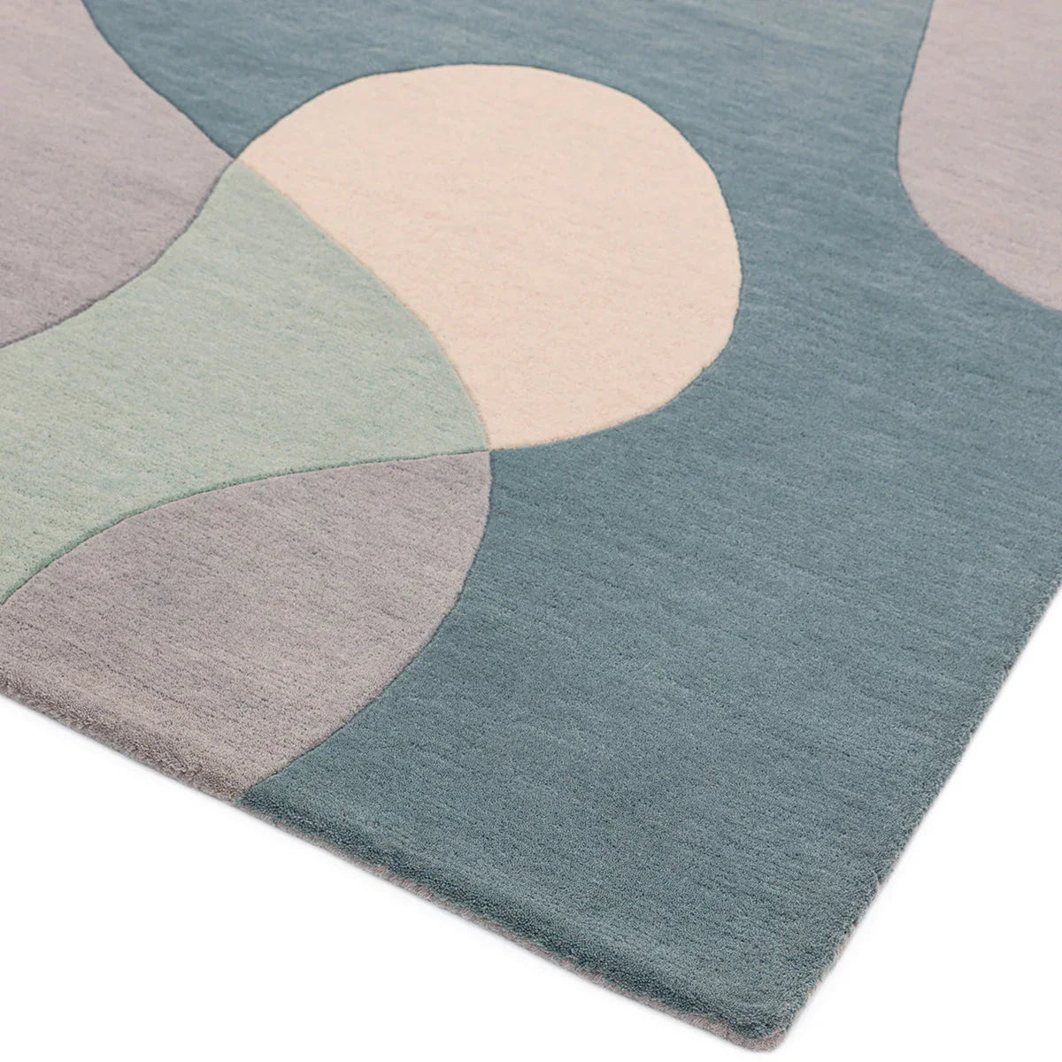 Asiatic Matrix Max Arc Sky Designer Rug featuring abstract arc pattern in teal blue, cream, sage green and lavender on blue background, machine-made rug