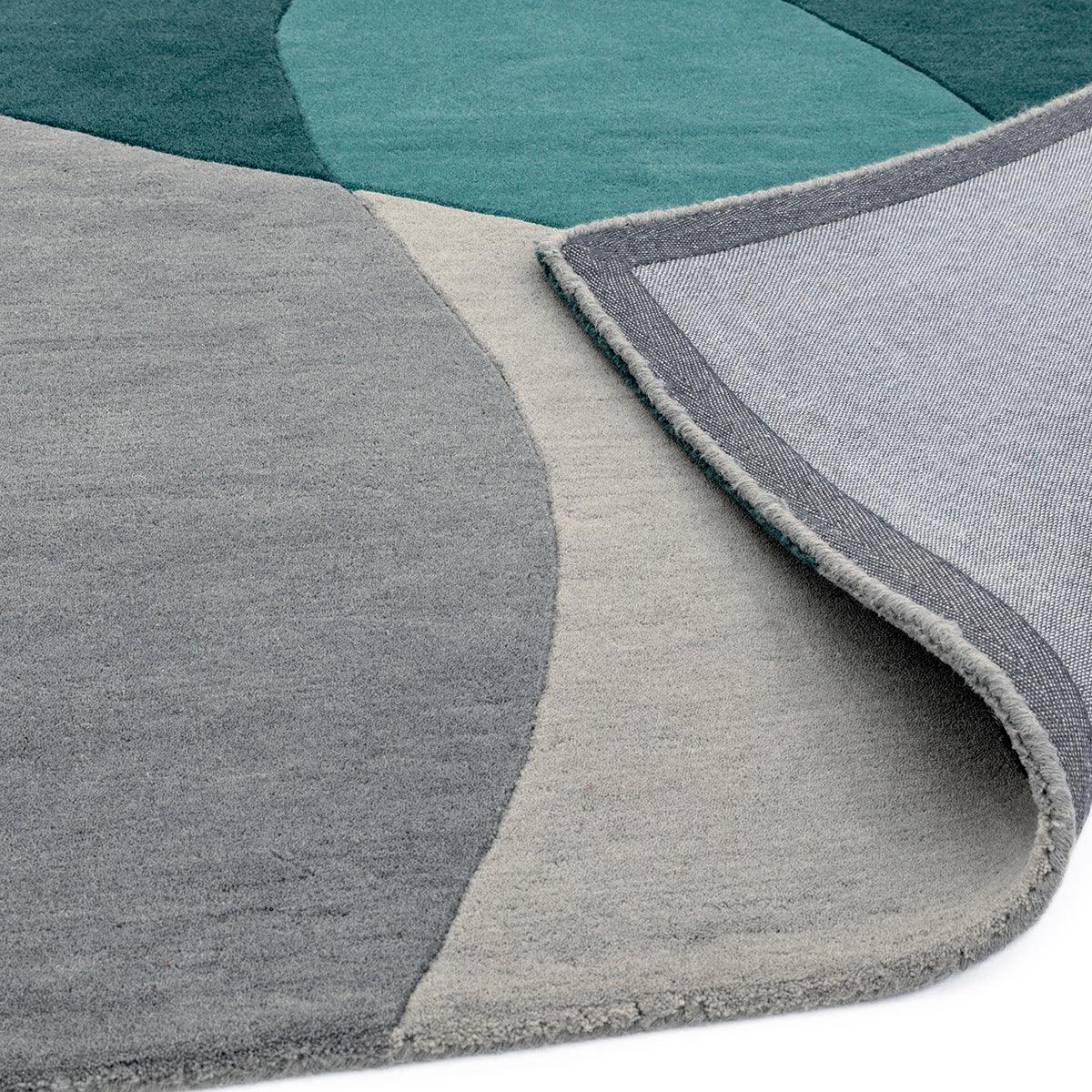 Asiatic Matrix Max Arc Teal rug with geometric arc pattern in teal, teal-grey, grey and ivory on light grey, machine-woven polypropylene