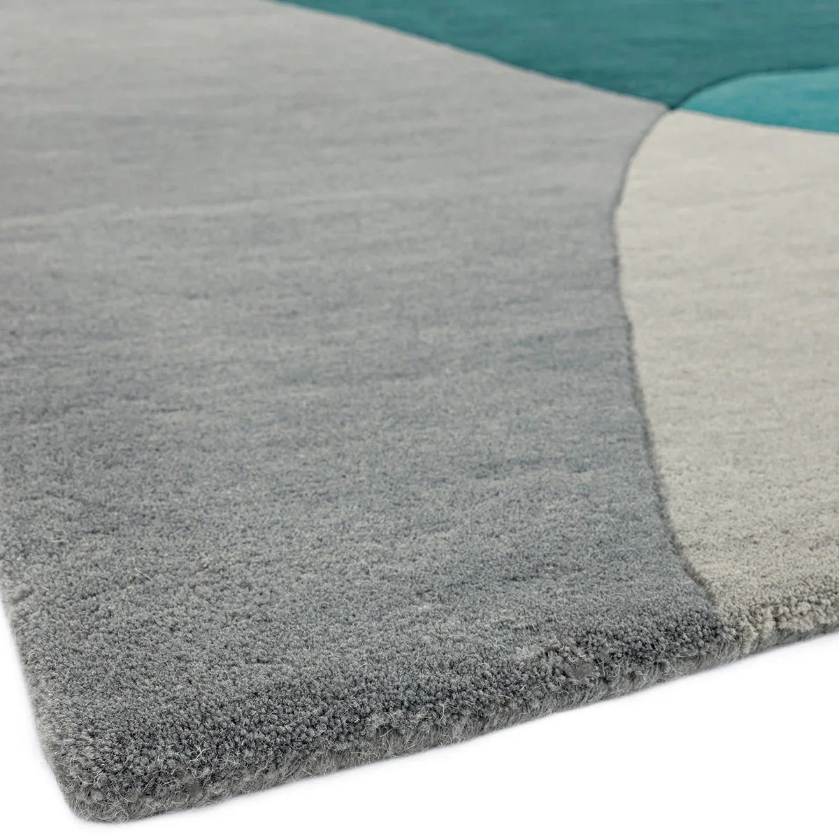 Asiatic Matrix Max Arc Teal Designer Rug featuring geometric arc pattern in teal, charcoal, taupe and cream on light grey background, hand-tufted wool