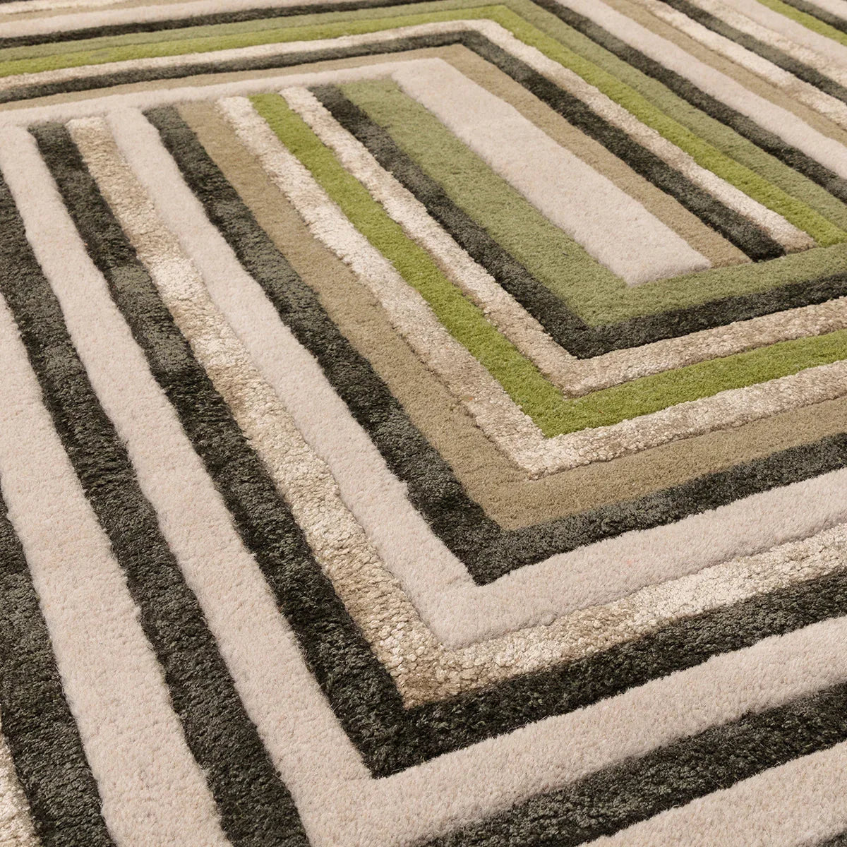 Asiatic Matrix Network Forest Rug featuring geometric concentric stripes in forest green, olive, beige, cream and charcoal on cream background, hand-tufted wool