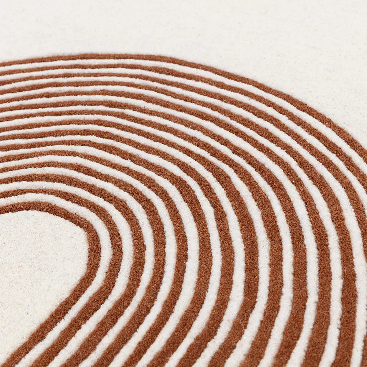Asiatic Matrix 85 Arches Amber Rug featuring concentric arch pattern in amber brown and ivory on cream background, hand-tufted wool