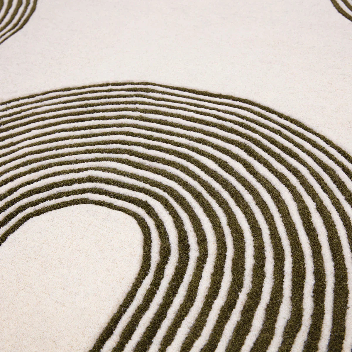 Asiatic Matrix Arches Forest Designer Rug featuring concentric arch pattern in forest green and ivory on cream background, machine-made wool