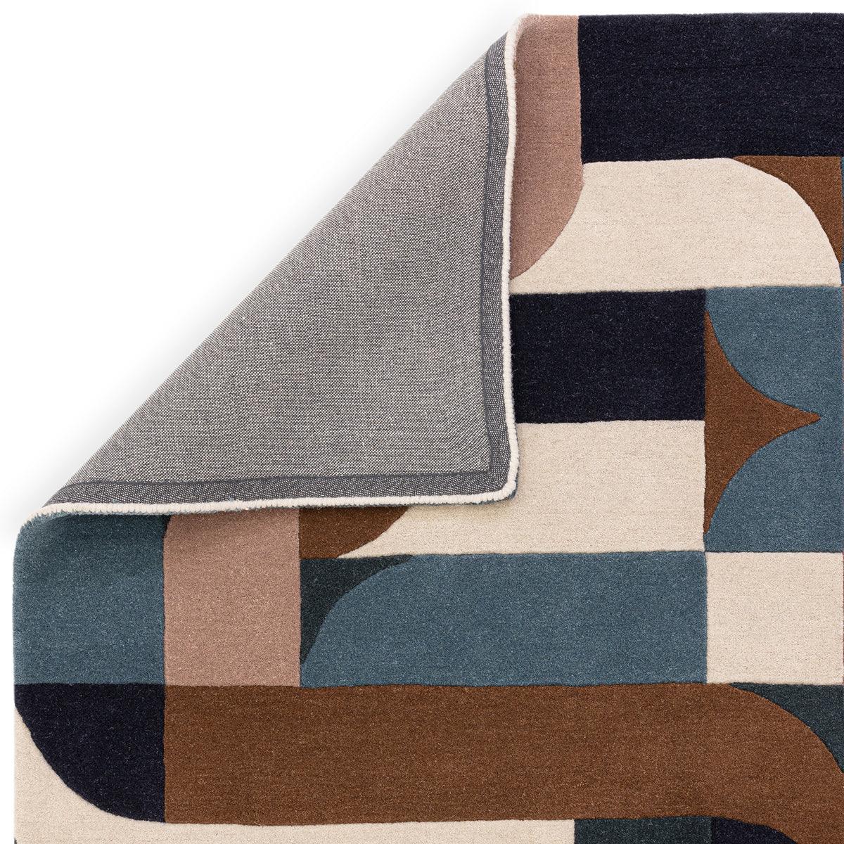 Asiatic Matrix 89 Klotski Teal Rug featuring abstract geometric blocks in teal, navy, beige and cream on light beige background, hand-tufted wool