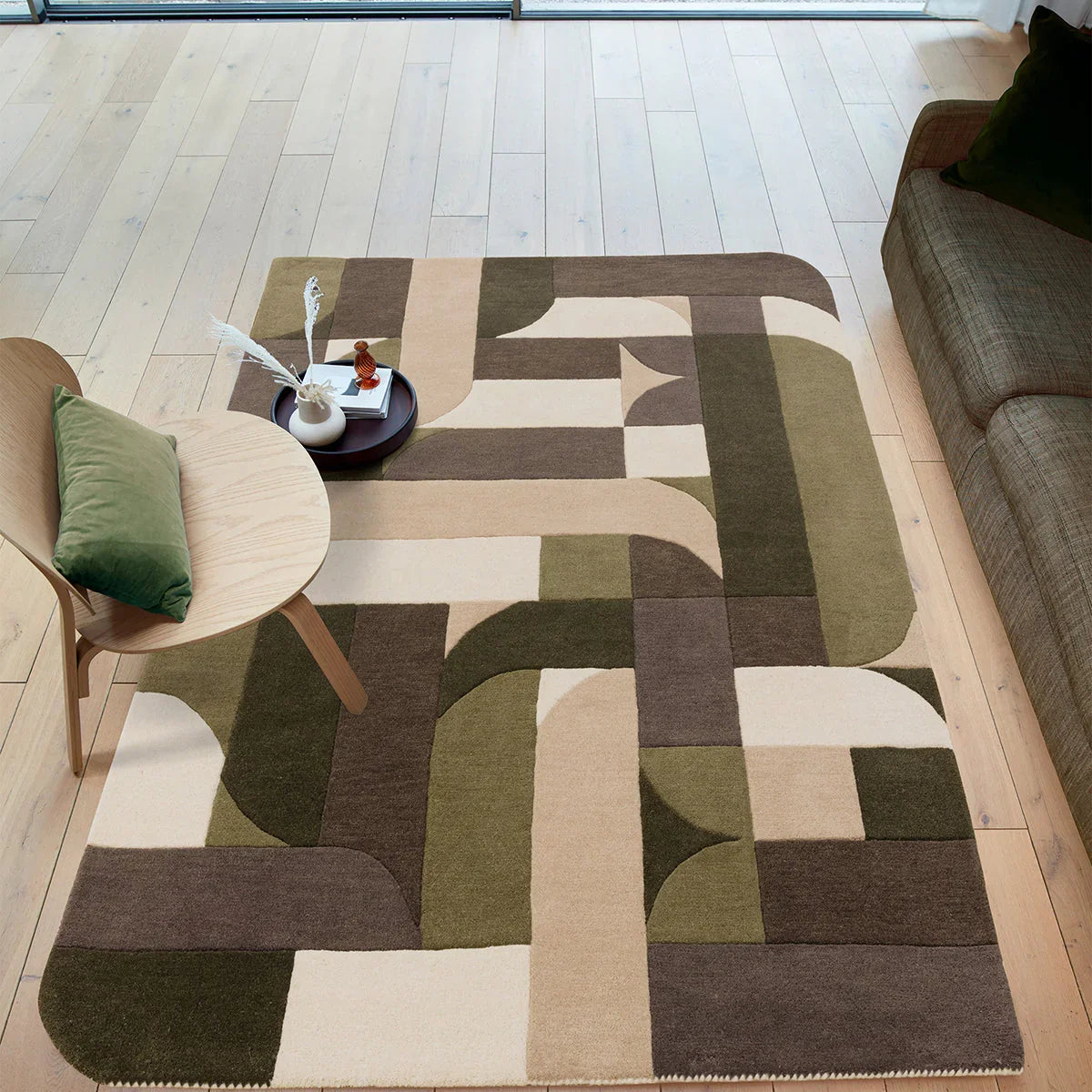 Geometric patterned rug on a wooden floor with furniture