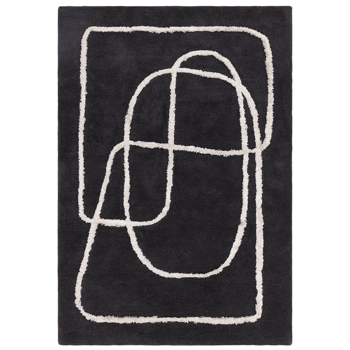 Black rug with white abstract patterns on a plain background
