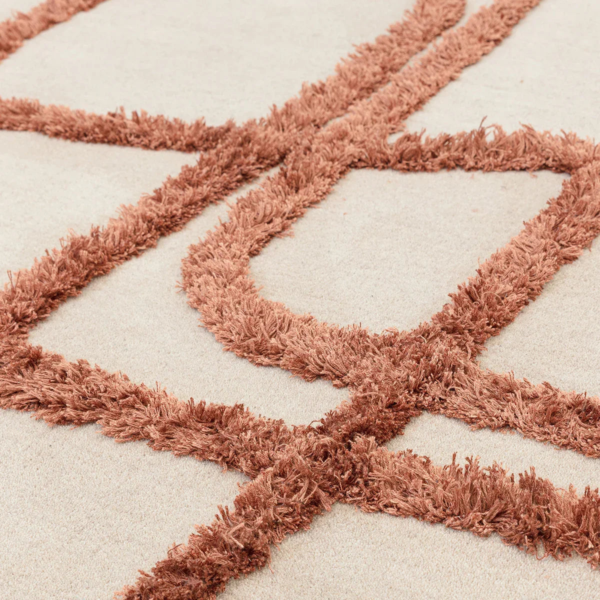 Asiatic Matrix Infinity Copper Designer Rug featuring geometric matrix pattern in copper on cream background, hand-tufted wool