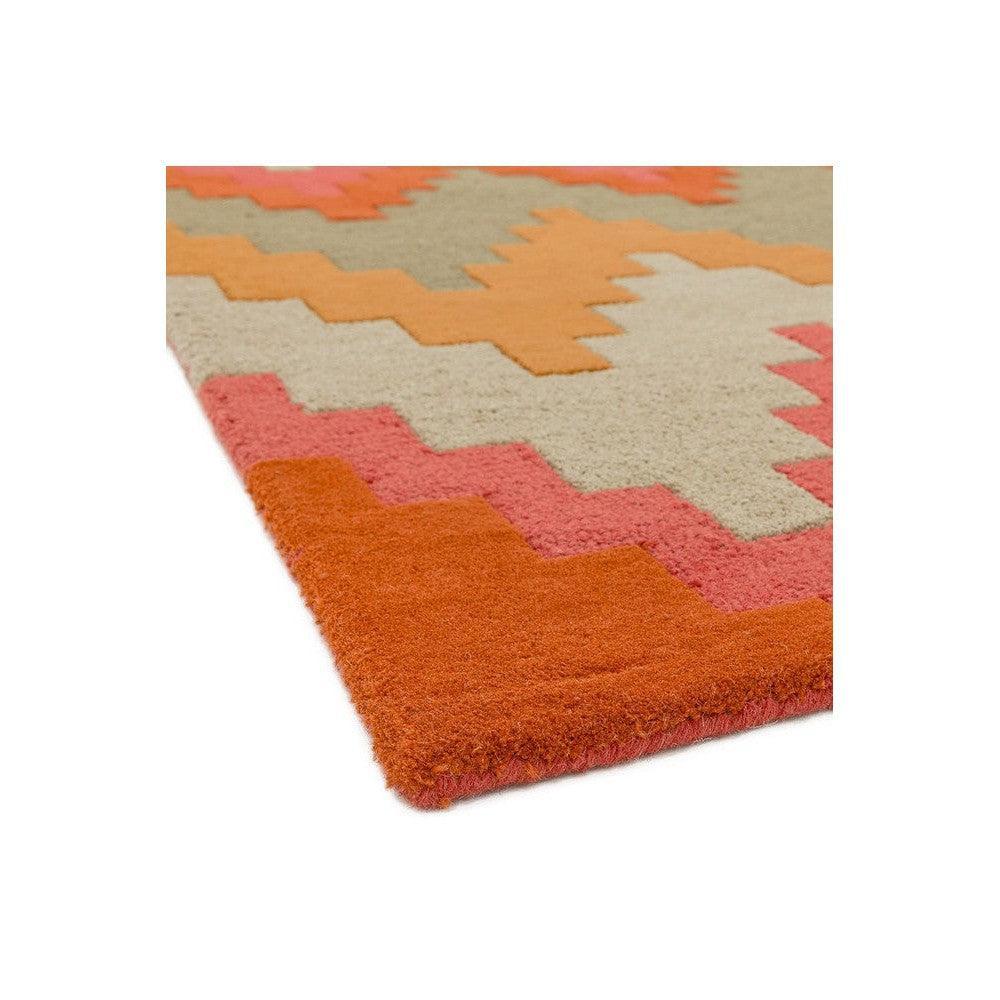 Asiatic Cuzzo Sienna Rug featuring zigzag chevron in coral pink, orange, cream on warm orange background, hand-tufted wool