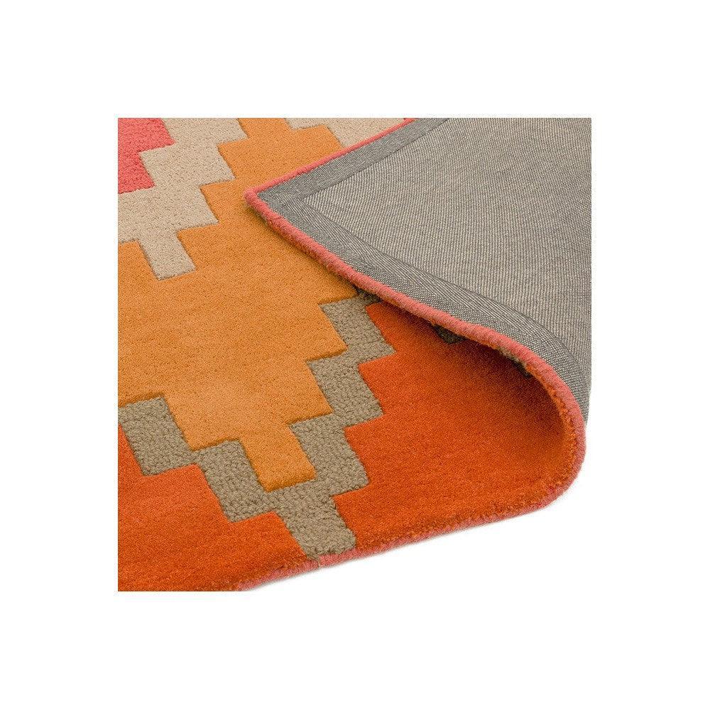 Asiatic Cuzzo Sienna Rug featuring geometric zigzag in burnt orange, taupe and grey on orange background, hand-tufted wool