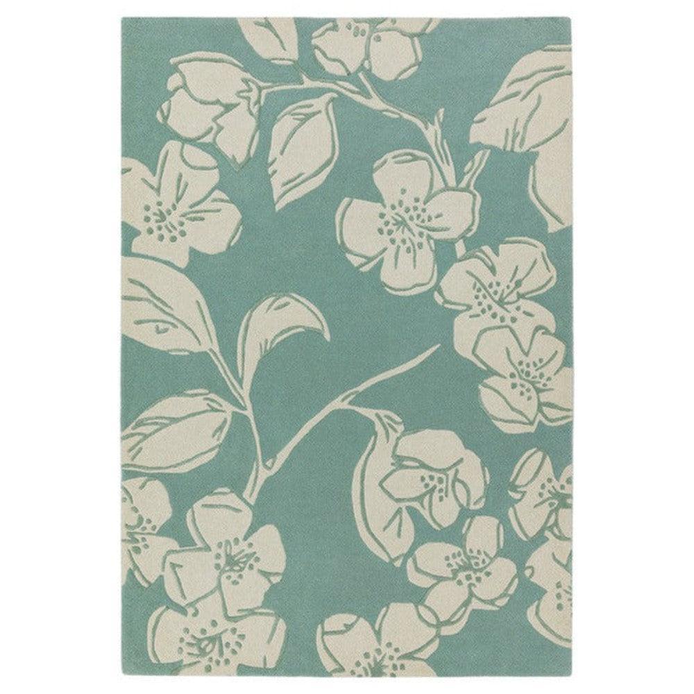 Asiatic Devore Blue Designer Rug featuring floral motif in cream on teal background, hand-tufted wool