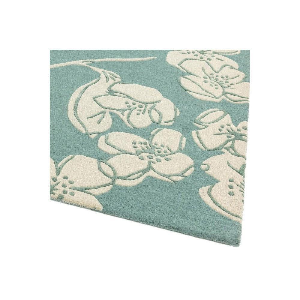 Asiatic Devore Blue Designer Rug featuring white floral pattern on teal background, hand-tufted wool