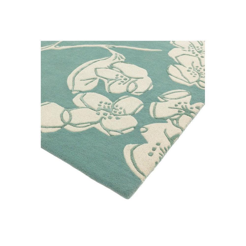 Asiatic Devore Blue Designer Rug featuring ivory floral pattern in teal on teal background, machine-woven wool blend