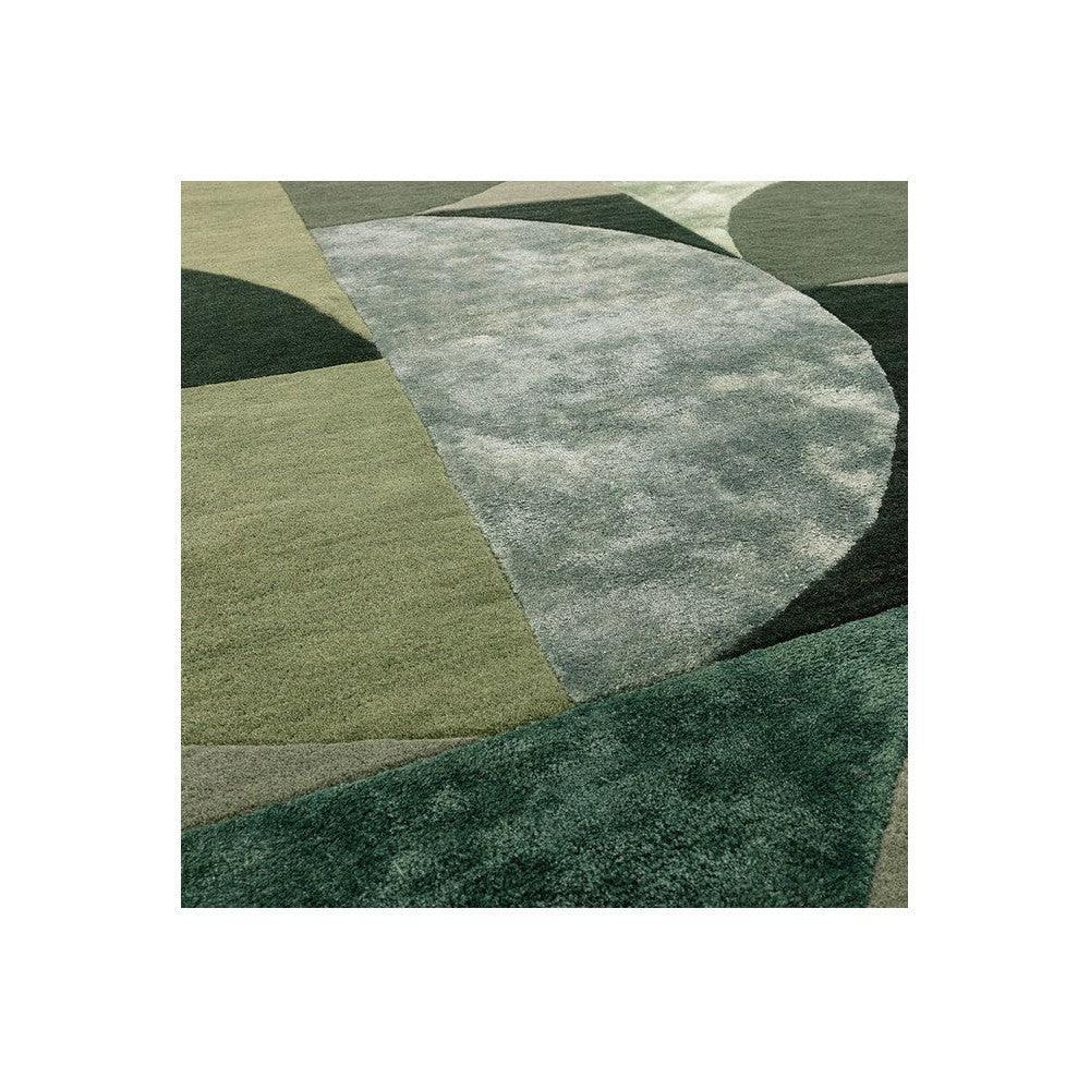 Asiatic Oval Forest Rug featuring abstract geometric shapes in forest green, olive, sage and cream on light background, hand-tufted wool