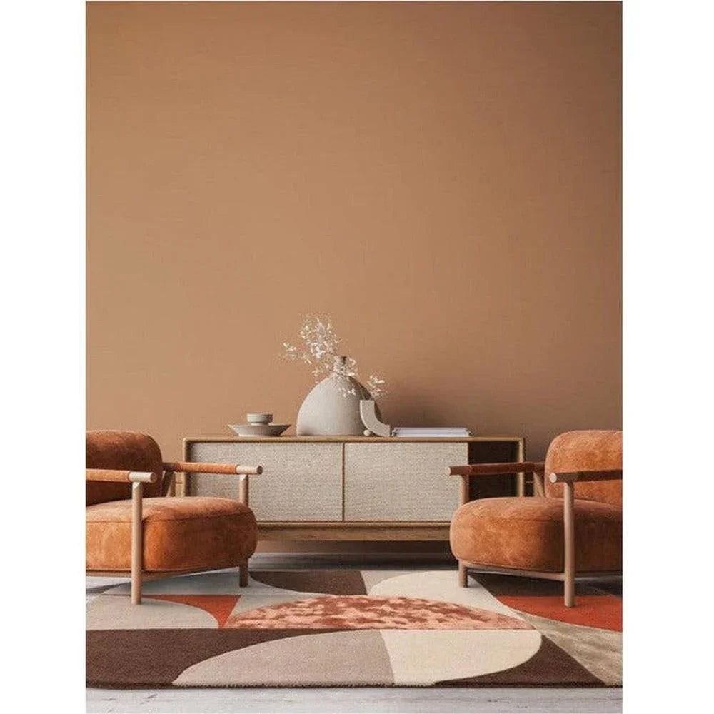 Asiatic Oval Spice Designer Rug featuring geometric pattern in burnt orange, cream, brown and beige on warm terracotta background, hand-tufted wool