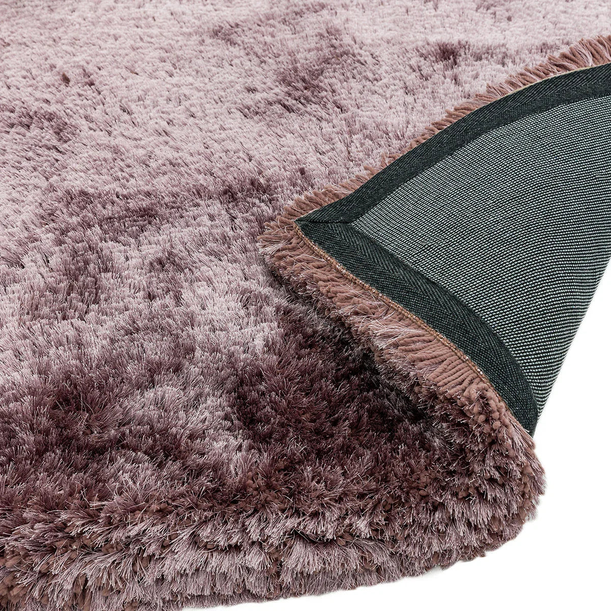 Asiatic Plush Dusk Designer Rug featuring shaggy pile in dusty rose/mauve with charcoal edging on pale pink background, plush rustic style