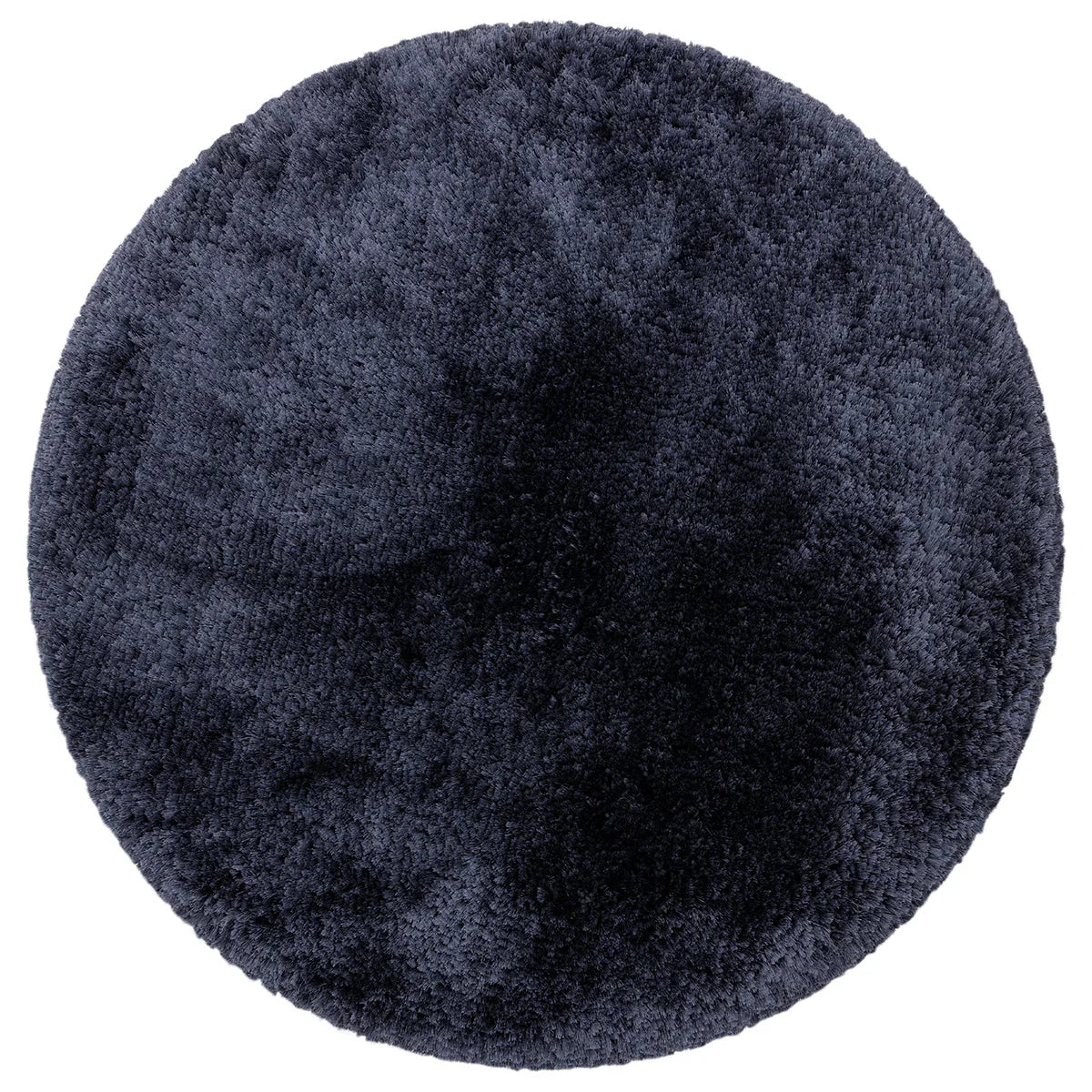 Asiatic Plush Navy Round round rug styled in a living room