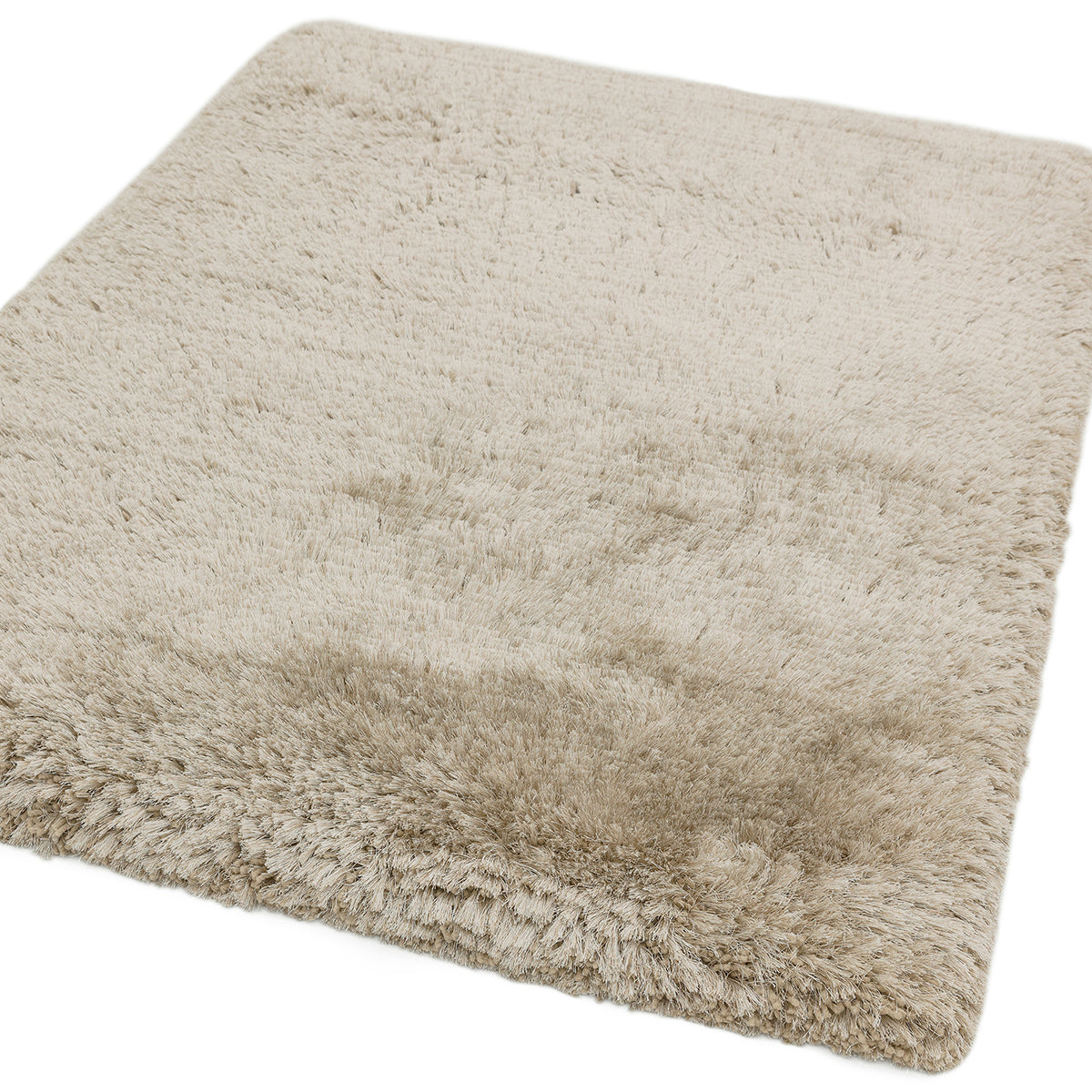 Beige fluffy rug on a white background