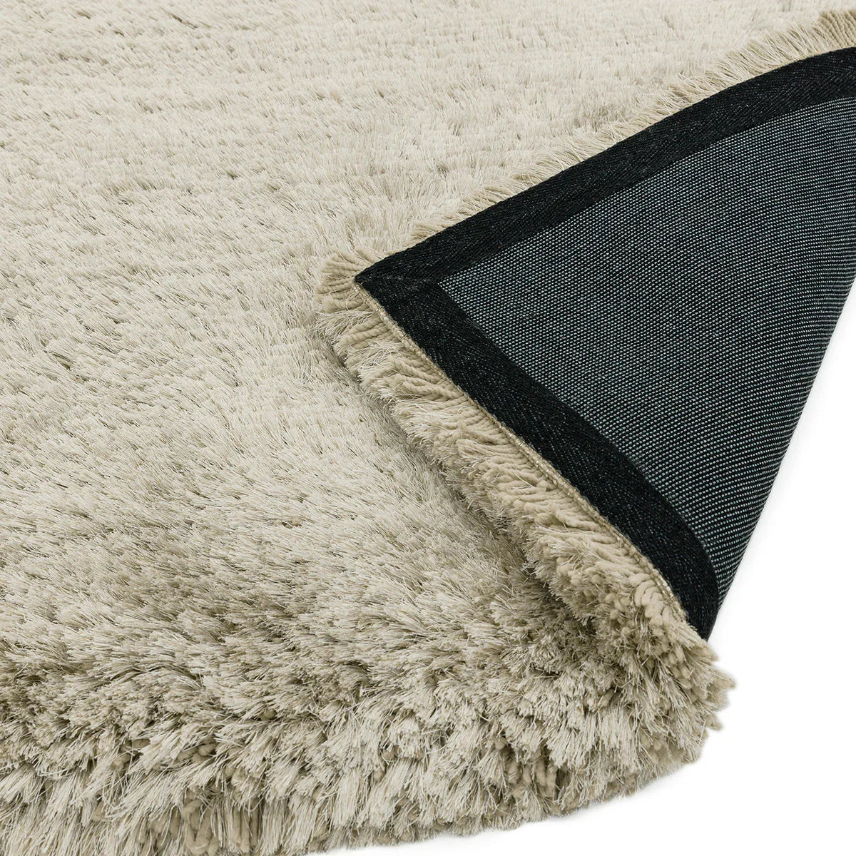Asiatic Plush Pearl Designer Rug featuring shaggy pile in ivory, cream and beige with charcoal backing on ivory backdrop, power-loomed wool