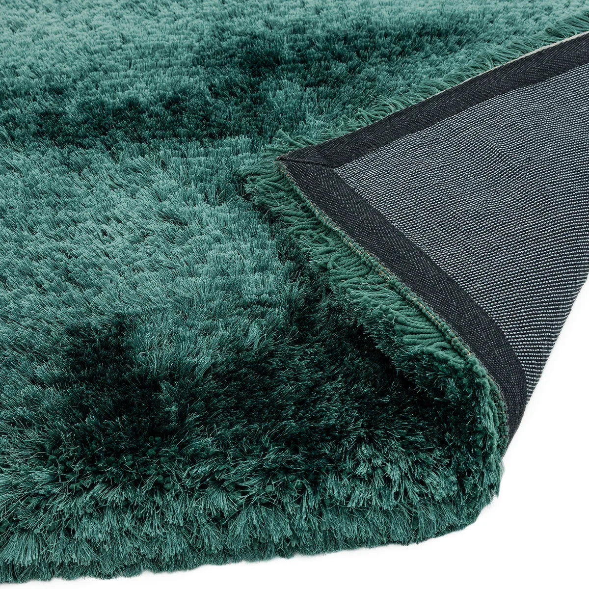Asiatic Plush Petrol Designer Rug featuring solid shag pile in petrol teal on dark backing, hand-tufted wool-blend