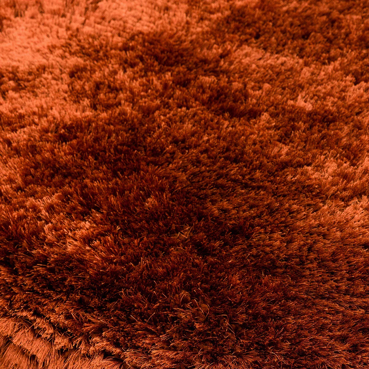 Asiatic Plush Rust Round Rug featuring plush shag in rust, burnt orange and copper on terracotta background, tufted wool