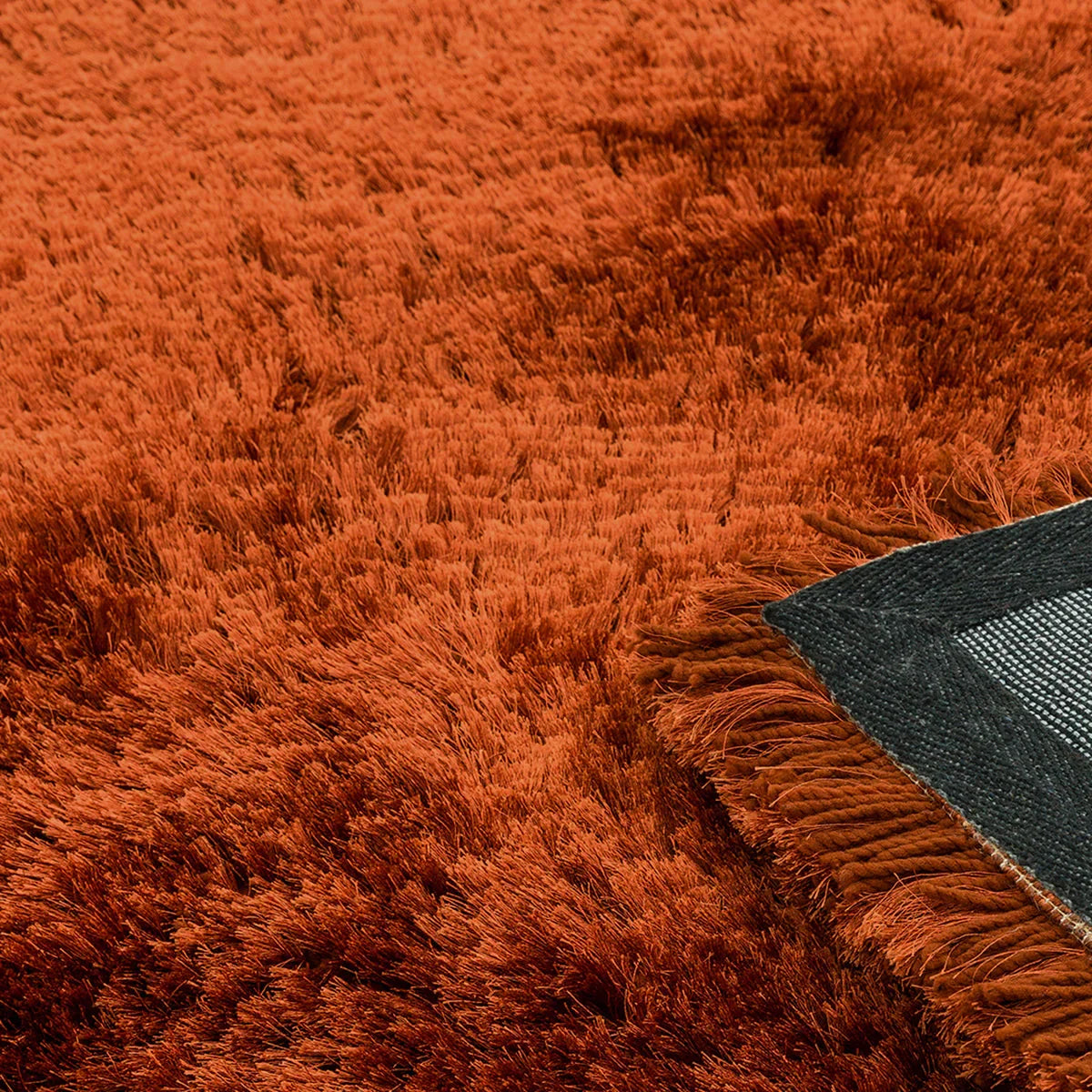 Asiatic Plush Rust Round Designer Rug featuring shag in rust, burnt orange and copper on charcoal backing, hand-tufted wool