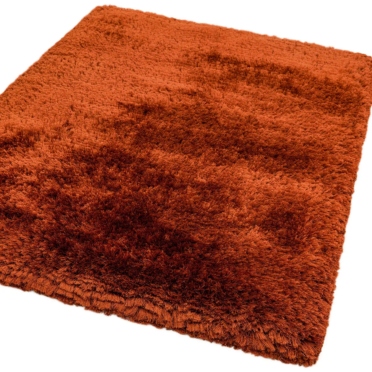 Asiatic Plush Rust Designer Rug featuring shag texture in rust orange on white background, hand-tufted wool