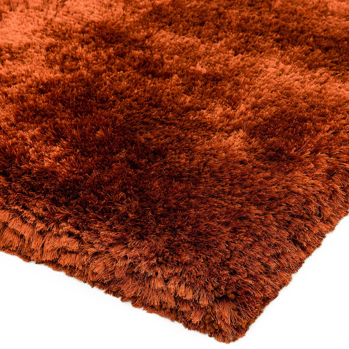 Asiatic Plush Rust Designer Rug featuring shaggy plush texture in rust orange on white background, hand-tufted wool