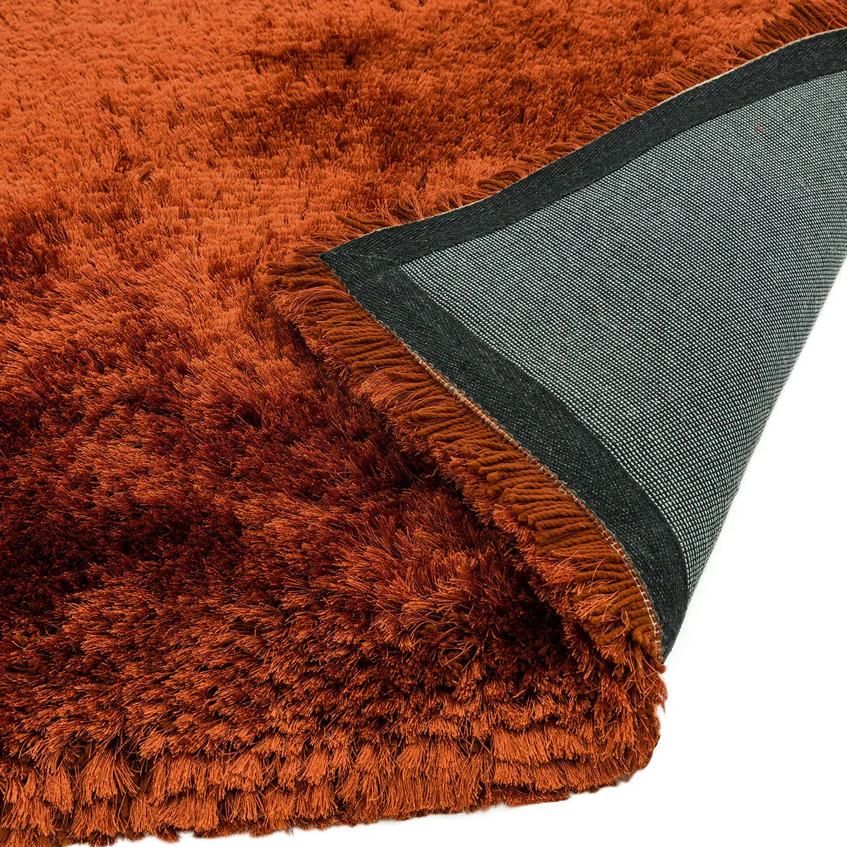 Asiatic Plush Rust Designer Rug featuring shaggy rust pile on charcoal backing, machine-made polyester