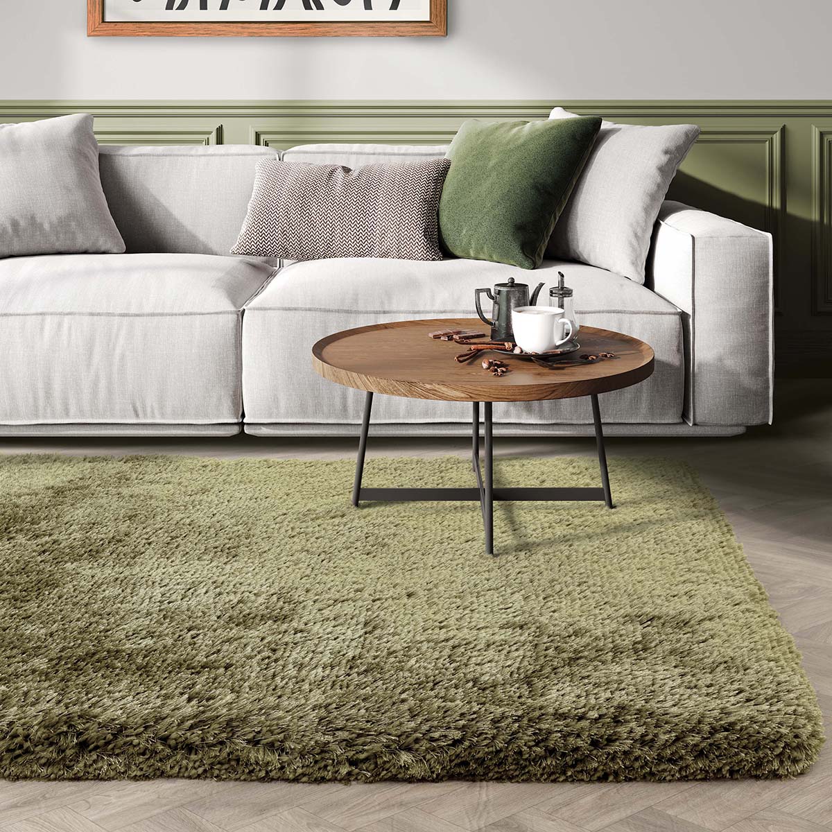 Living room with a gray sofa, green rug, and wooden coffee table.