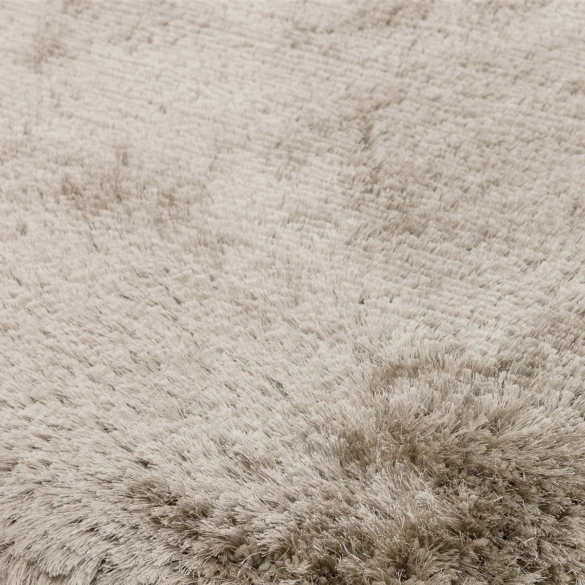 Asiatic Plush Sand Round Designer Rug featuring plush shag in sand beige cream on warm sand background, hand-tufted wool