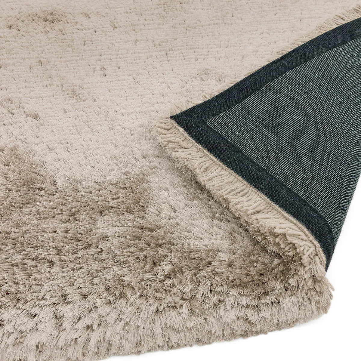 Asiatic Plush Sand Designer Rug featuring shaggy beige pile with dark blue border on light sand background, machine-made synthetic fibre