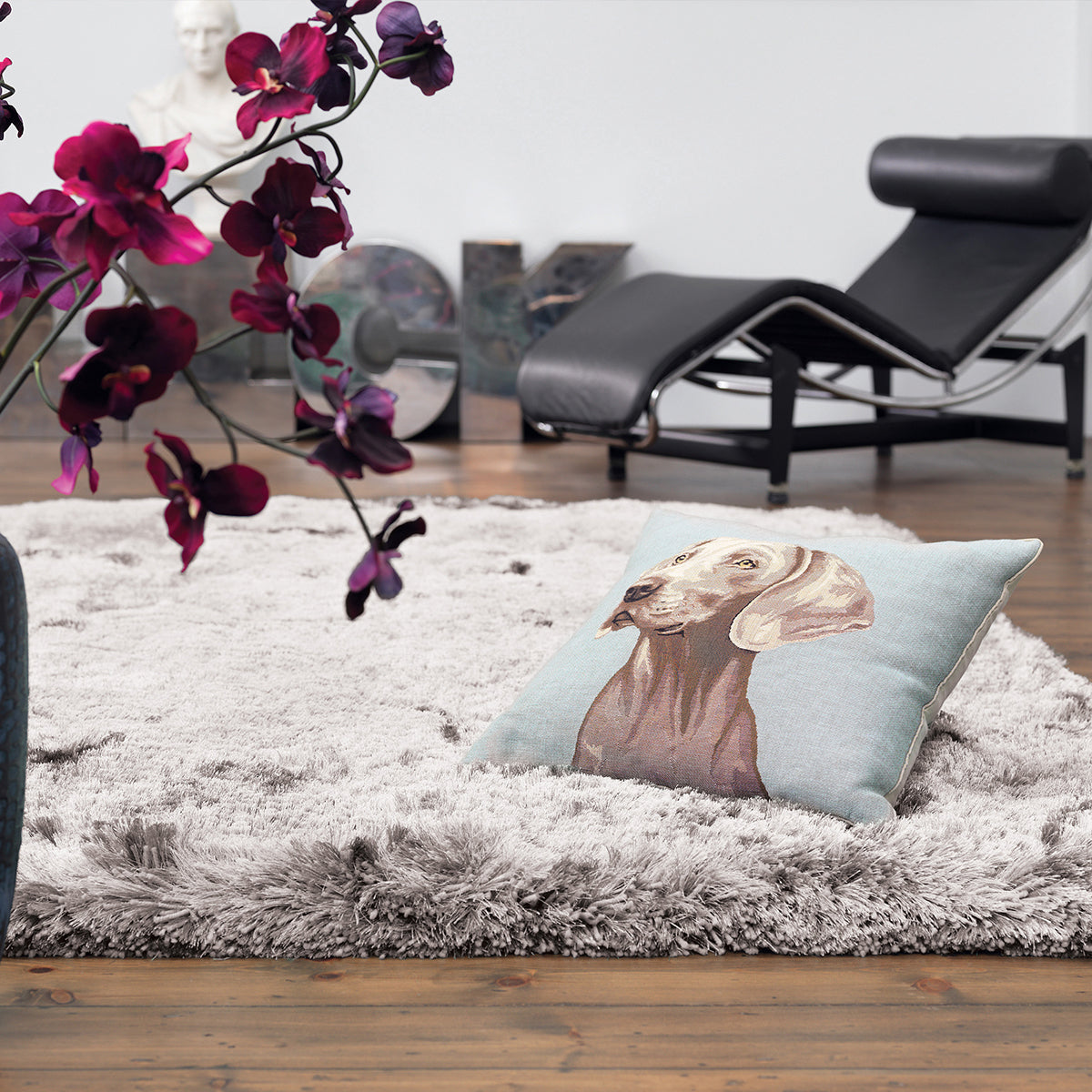 Decorative pillow with a dog design on a fluffy rug in a living room setting.