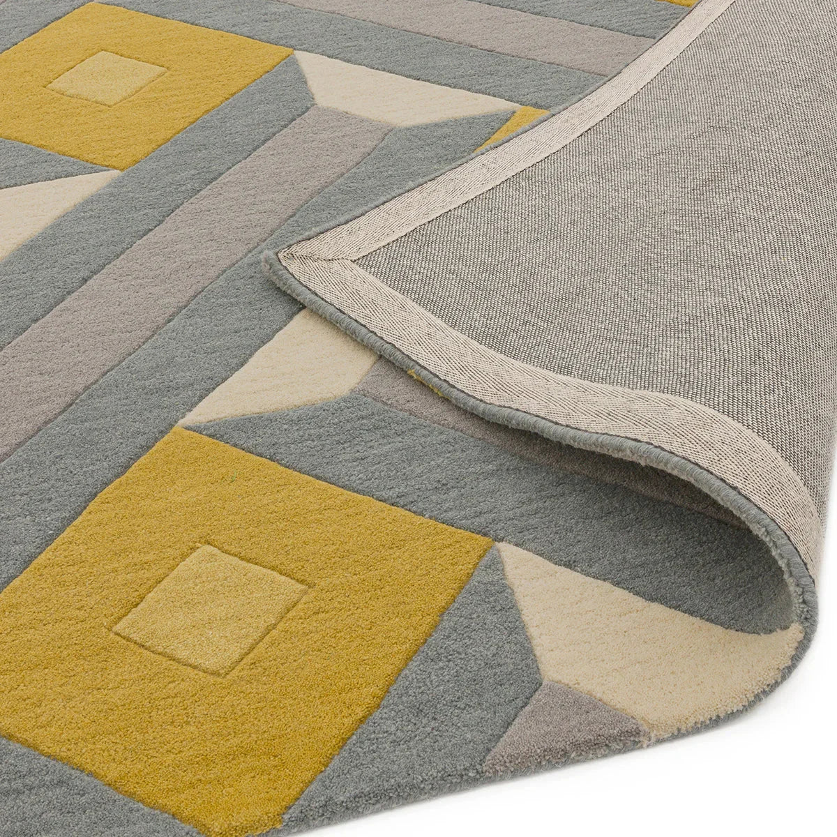 Asiatic Reef Motif Ochre Grey rug featuring geometric reef pattern in ochre, grey and cream on pale grey, hand-tufted wool