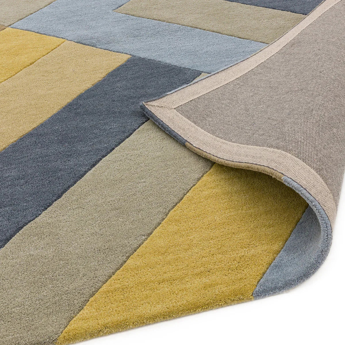 Asiatic Reef Big Zig Ochre Grey Rug featuring zigzag patchwork in ochre, blue-grey and taupe on beige ground, machine-woven